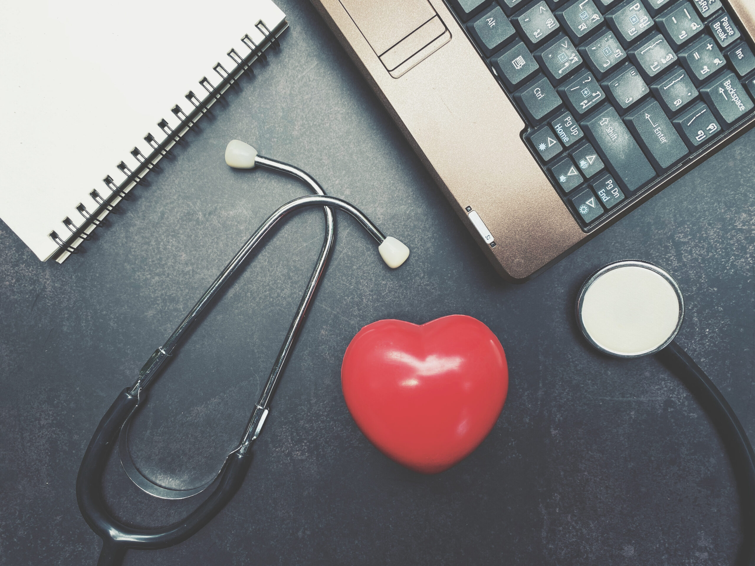 Close,Up,Red,Heart,,Stethoscope,,Notebook,And,Computer,On,Table,